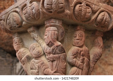 Huesca, Spain - October 8, 2014: Reddish Romanesque Sandstone Capital Depicting A Biblical Scene At The Cloister Of Royal Monastery Of San Juan De La Peña