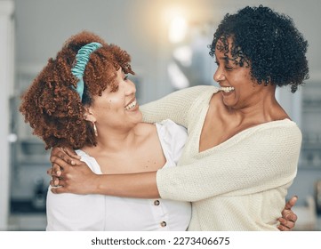 Hug, happy and a mother and daughter with admiration, love and laughing in the living room. Smile, affection and an African mom and woman hugging on mothers day during a visit or reunion together
