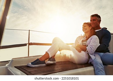 Hug, sunset and couple on a yacht for travel, retirement holiday and ocean adventure in Spain. Investment, hobby and man and woman on a boat for a luxury cruise, sailing and happiness at sea - Powered by Shutterstock