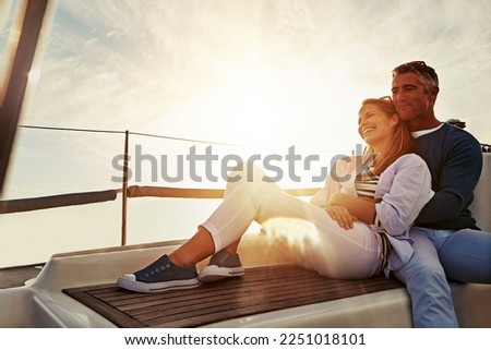 Hug, sunset and couple on a yacht for travel, retirement holiday and ocean adventure in Spain. Investment, hobby and man and woman on a boat for a luxury cruise, sailing and happiness at sea