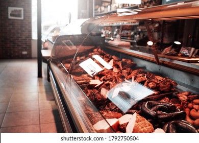 Huge Assortment Of Meat Selection. A Shop With A Row Of Stalls Full Of Meat. Butcher Shop Inside.