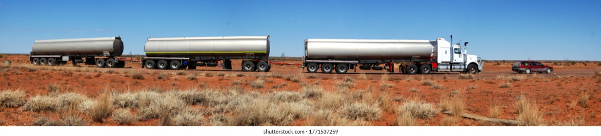 Huge Australia Road Train Comparison With Station Wagon Car In The Red Dirt Outback