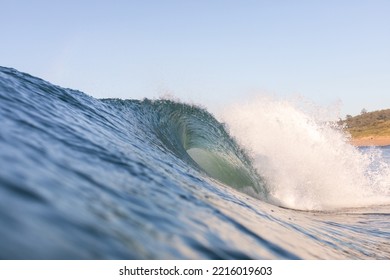 Huge Barrelling Surf Wave Crashing On A Beach