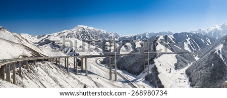 Huge and beautiful road bridge in snowy mountains