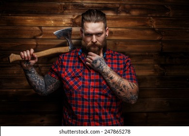 Huge Brutal Man With Beard And Tattooes Holding Axe