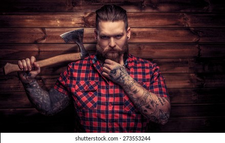 Huge Brutal Man With Beard And Tattooes Holding Axe