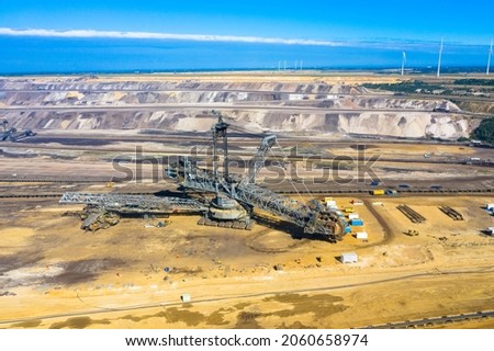 A huge bucket-wheel excavator digging coal on the open-pit mine. Garzweiler open cast mine, Jackerath.
Aerialview of the largest lignite mining factory in Europe located in North Rhine-Westphalia.
