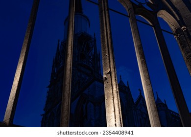 Huge cathedral darkened in the evening seen through a gothic mullioned window. Ancient and gothic architecture. Rock columns stretched upwards. Charm and mystery. - Powered by Shutterstock