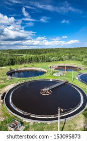 Huge circular settlers of sewage treatment plant under blue sky