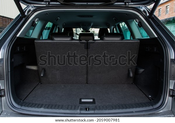 Huge, clean and empty car trunk in interior of\
a modern compact suv. Rear view of a SUV car with open trunk. Car\
trunk interior.