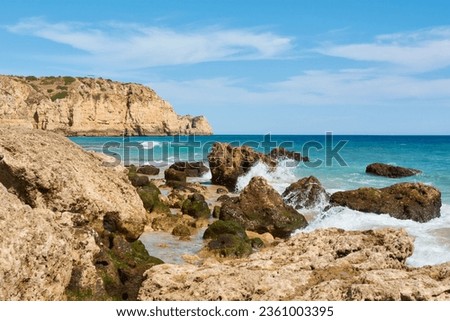 Huge cliffs and limestone rocks washed by the ocean waves in Lagos, Portugal