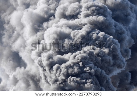 Huge clouds of smoke against the sky, a large fire at a construction site