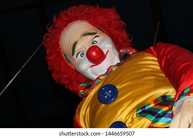 A huge colorful clown looking down. - Powered by Shutterstock