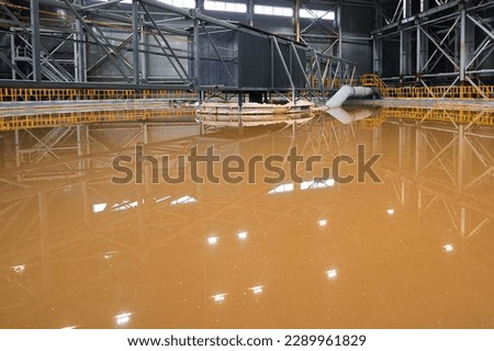 Huge container to separate liquid pulp material in workshop