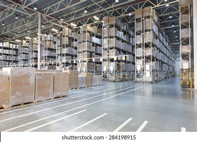 Huge distribution warehouse with boxes on high shelves