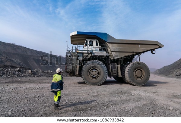 Huge Dump truck, worker,\
coal mine