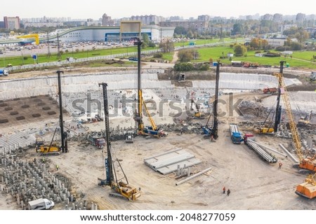 Huge excavation and foundation construction, drilling piles in urban development, aerial view