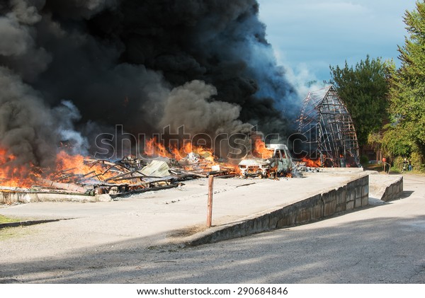 Huge fire of buildings and cars in\
industrial area of Vilnius, Lithuania. Black smoke is rising up to\
the sky. Representative picture for insurance, damage, loss,\
accidents and other situations.\
