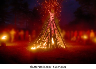 Huge Fire At Night And Young People Around. Pagan Festival Of Walpurgis Night: Bonfires, Dancing Wildly, Circle Dance, Witches. Folk Festival. German Legends, St. Walburgas, Satanism, Devil