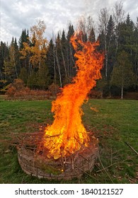 Huge Flames From An Outdoor Firepit In A Backyard. 