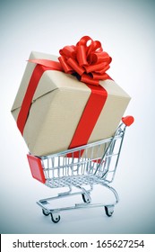 A Huge Gift With A Red Ribbon In A Shopping Cart