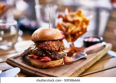 Huge Gourmet Burger With Onion Rings And Fries