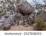 Huge granite boulders, rounded by weathering, balanced on top of each other to form an archway formation in Girraween National Park in the granite belt of Queensland, Australia.