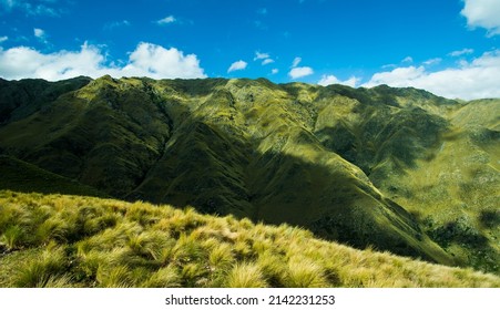 Huge green mountains with blue sky and clouds