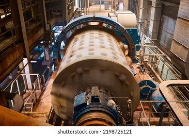 Huge grinding ball mill operates with mineral ore at plant - Shutterstock ID 2198725121