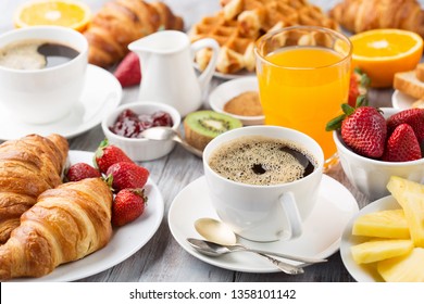 Huge healthy breakfast on white wooden table with coffee, orange juice, fruits, waffles and croissants. Selective focus. Good morning concept. - Powered by Shutterstock