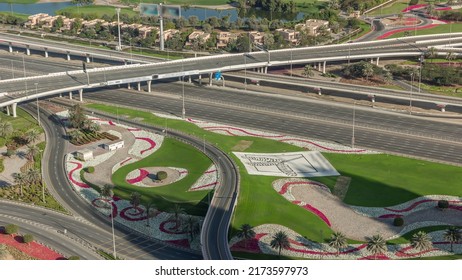 Huge Highway Crossroad Junction Between JLT District And Dubai Marina Intersected By Sheikh Zayed Road Aerial Timelapse With Busy Traffic On Overpass. Green Lawn And Flowerbed