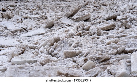 Huge Ice Loads Drift In The River Ogre, Latvia. Congestion On The River In The Spring. A Large Cluster Of Moving Ice Blocks