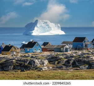 Huge icebergs lining the shores of the charming town of Qeqertarsuaq (formerly Godhavn) on the south coast of Disko Island, Western Greenland. - Shutterstock ID 2209845265