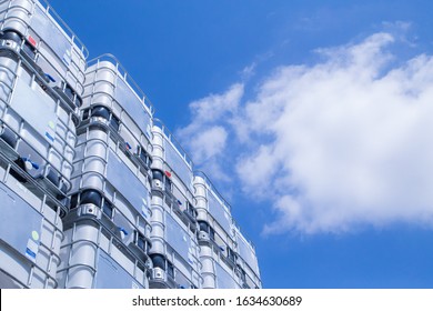 Huge industrial IBC outdoor storage with blue sky above. - Shutterstock ID 1634630689