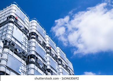 Huge industrial IBC outdoor storage with blue sky above. - Shutterstock ID 1634630692