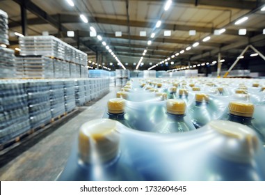 A Huge Industrial Warehouse With Plastic Food Wrap Wrapped Plastic Bottles With Carbonated Drinks, Water Or Beer.