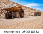 Huge large dump trucks at an open-pit copper mine in Peru.