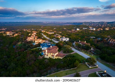 huge mansion homes aboe barton creek west hills of Austin Texas Sunset above rooftops and houses in million dollar Suburb 