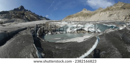 Huge melting hole in the Rhone Glacier in Switzerland showing the rapid melting of the ice. Panoramic image                              