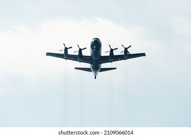 Huge military transport plane or bomber with propellers view from below. The concept of air clashes and armed conflicts