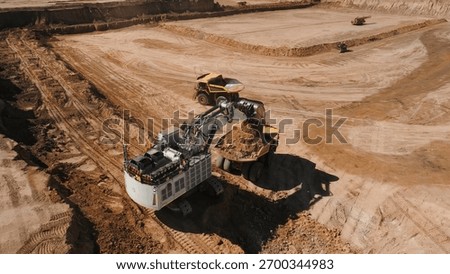 huge mining excavator in the process of extracting and loading minerals