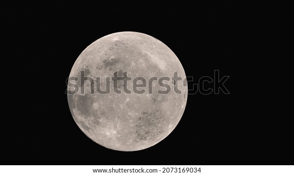 Huge moon, white,\
bright moon, satellite of the earth, against the background of a\
black gloomy space