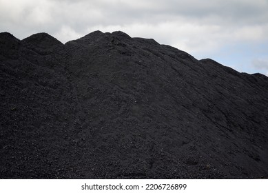 Huge Mountain Of Black Coal In A Concept Of Energy Crisis And Energy Shortage With Gray Sky In The Background