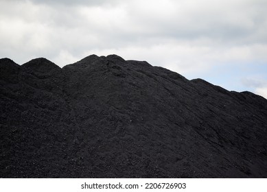 Huge Mountain Of Black Coal In A Concept Of Energy Crisis And Energy Shortage With Gray Sky In The Background