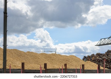 Huge Mountain Of Sawdust And Black Coal In A Concept Of Energy Crisis And Energy Shortage With Blue Sky In The Background