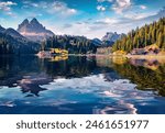 Huge mountain summit reflected in the calm waters of Misurina lake. Impressive summer view of National Park Tre Cime di Lavaredo, Location Auronzo, Misurina resort, Dolomiti Alps, South Tyrol, Italy.