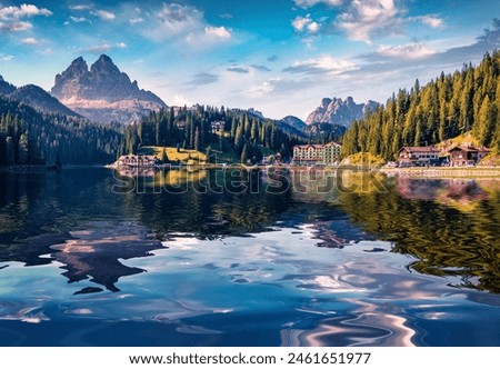 Huge mountain summit reflected in the calm waters of Misurina lake. Impressive summer view of National Park Tre Cime di Lavaredo, Location Auronzo, Misurina resort, Dolomiti Alps, South Tyrol, Italy.