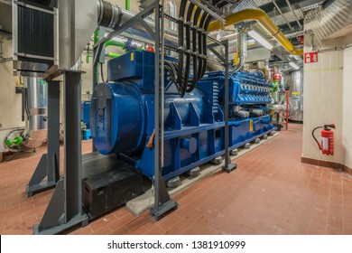 a huge natural gas engine works in a combined heat and power plant and supplies a district with heat