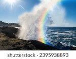 Huge Ocean Wave with a rainbow 
from refracting sunlight on the Oregon Coast created by King Tides from the alignment of the sun, moon, and earth orbits. 