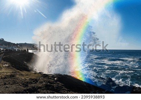 Huge Ocean Wave with a rainbow 
from refracting sunlight on the Oregon Coast created by King Tides from the alignment of the sun, moon, and earth orbits. 